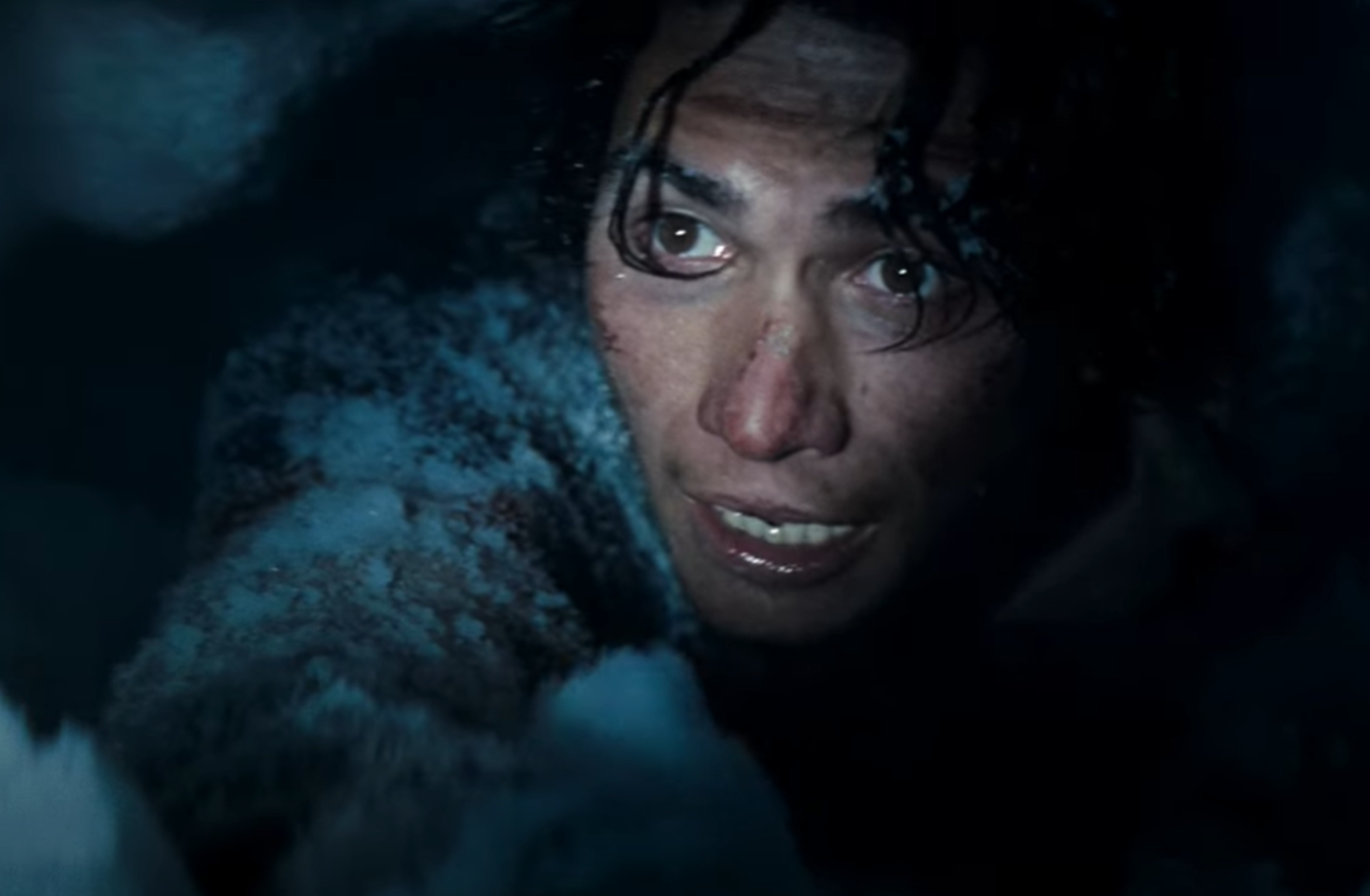 Screenshot of people digging in the snow - from Society of the Snow (2023)