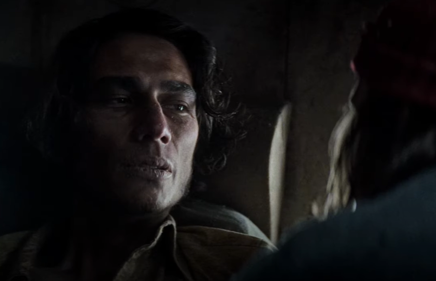 Screenshot of injured people looking scared in the plane body - from Society of the Snow (2023)