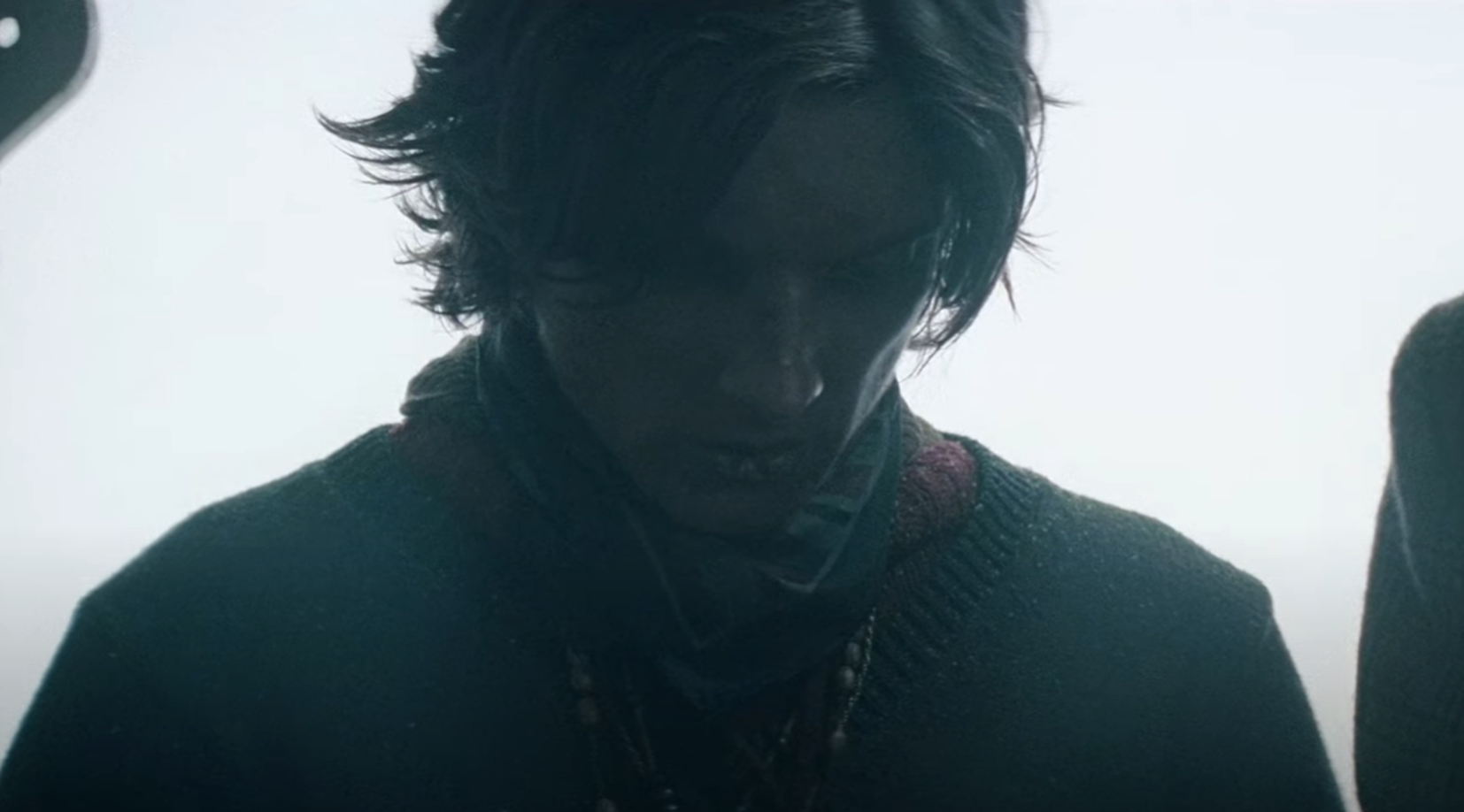 Screenshot of scared man looking down - from Society of the Snow (2023)