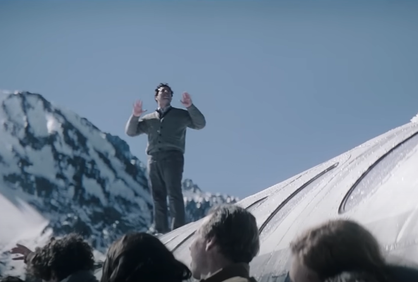 Screenshot of man talking to other people outside - from Society of the Snow (2023)