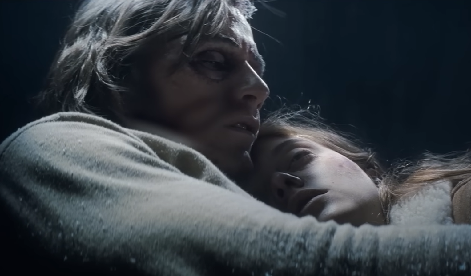 Screenshot of people hugging the plane - from Society of the Snow (2023)