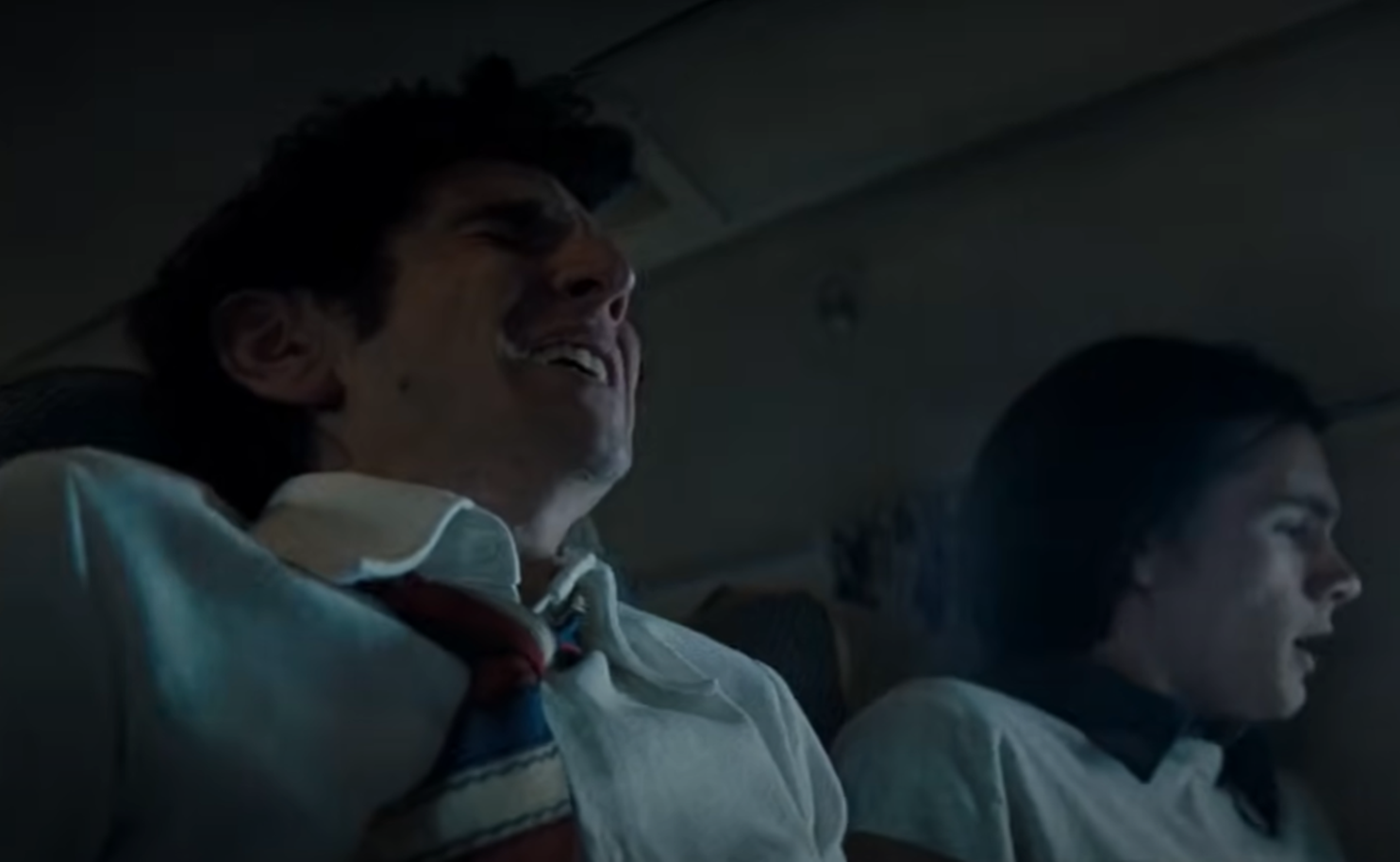 Screenshot of scared people on board on Flight 571 - from Society of the Snow (2023)
