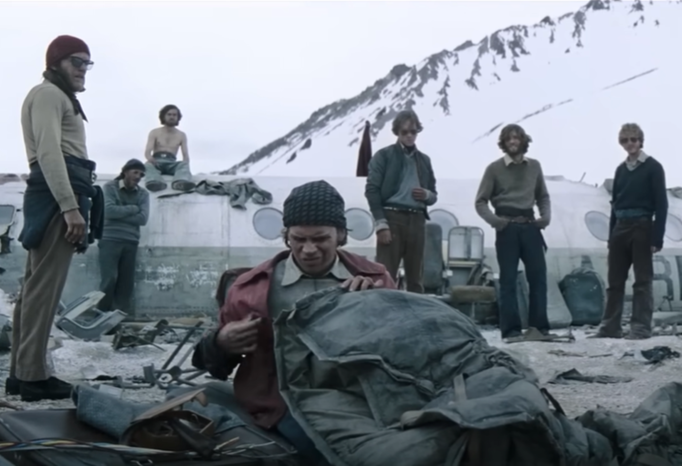 Screenshot of people looking scared outside - from Society of the Snow (2023)