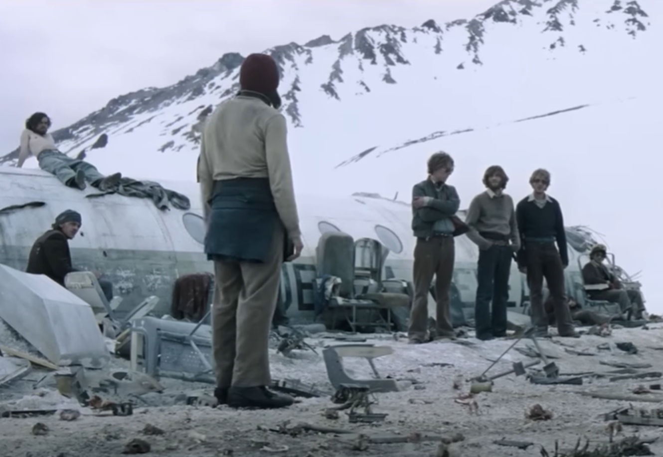 Screenshot of people looking scared outside - from Society of the Snow (2023)