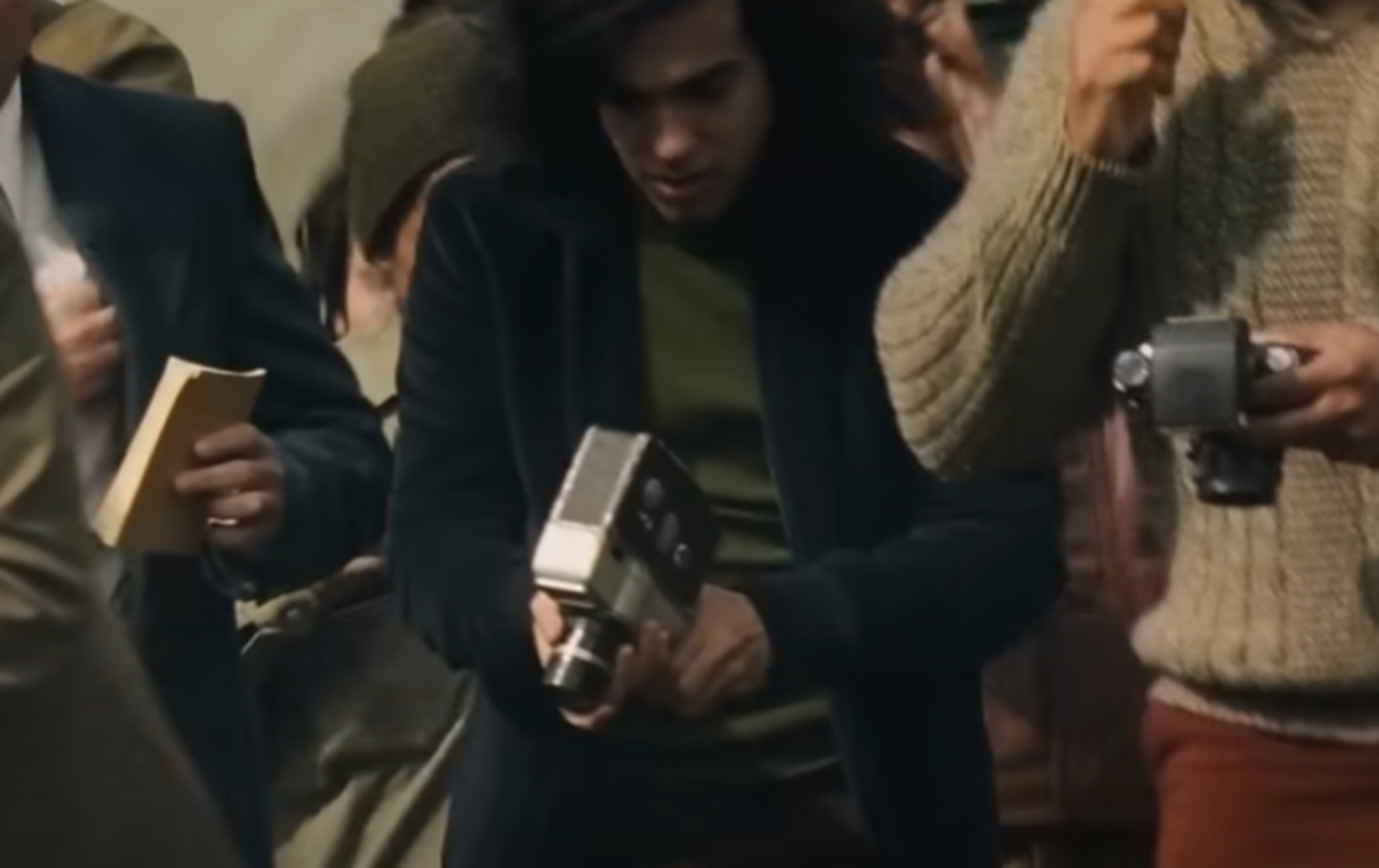 Screenshot of reporters waiting outside - from Society of the Snow (2023)