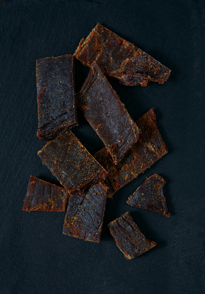 Beef jerky on black stone surface