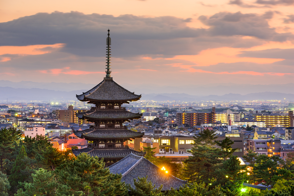 Nara, Japan pagoda and cityscape at dusk.
