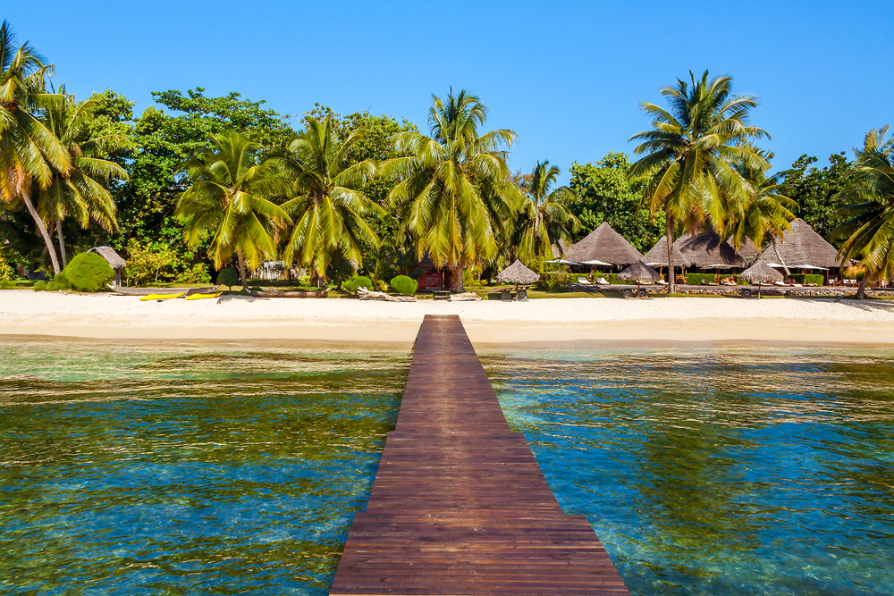 View of the tropical beach from the wooden pontoon