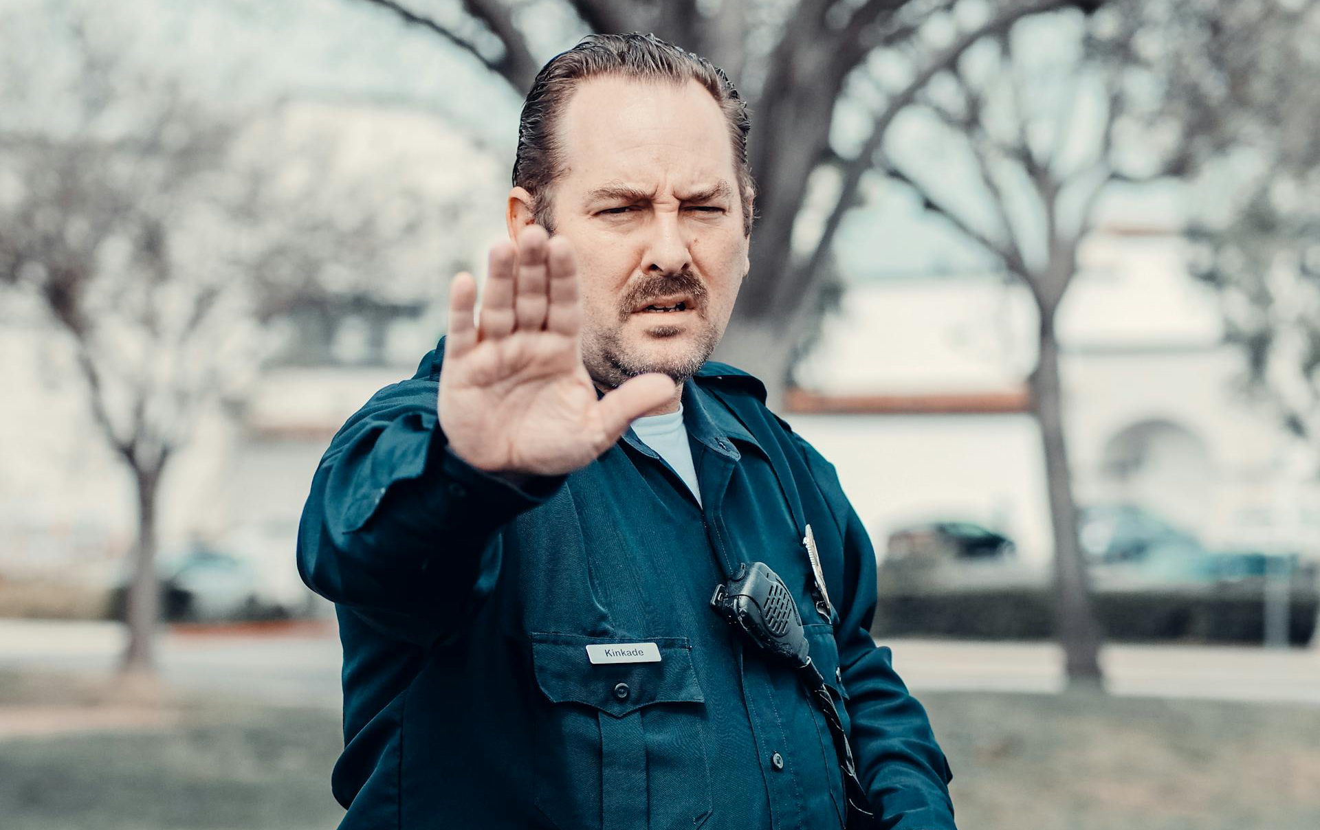 Man in police uniform stopping someone