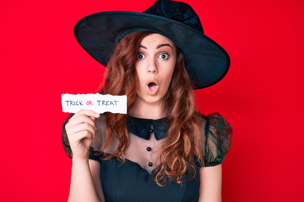 woman wearing witch Halloween costume shocked