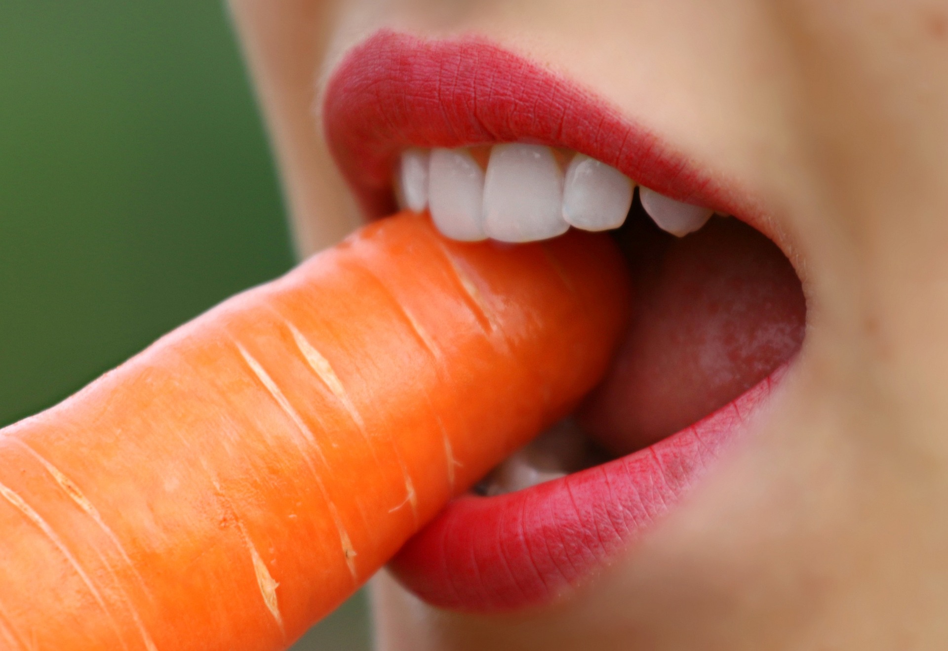 Person biting a carrot