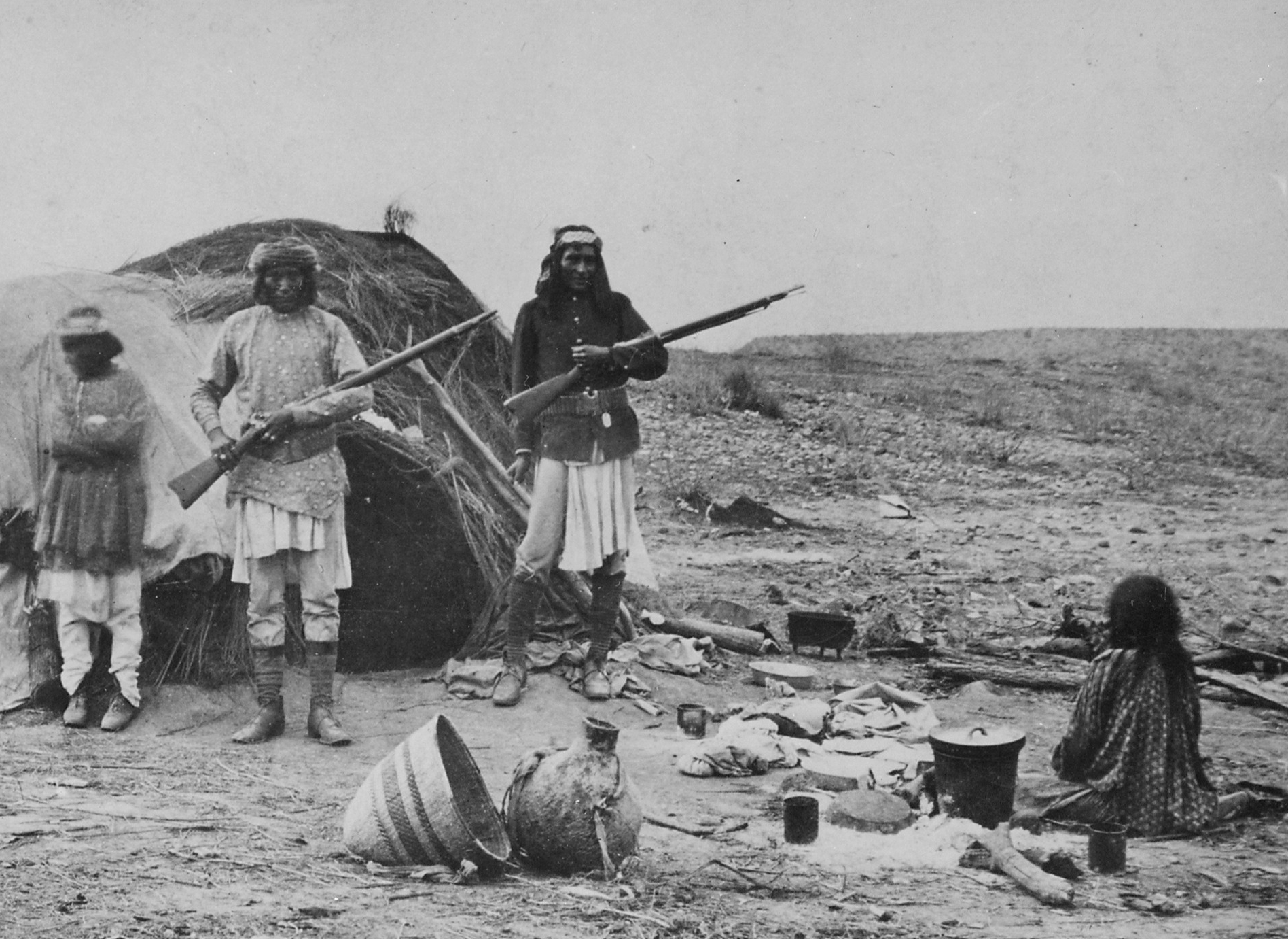 Apache Rancheria With Two Men Holding Rifles