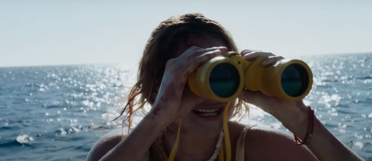 woman looking through telescope