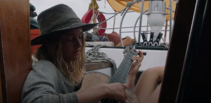 Woman playing on a broken guitar