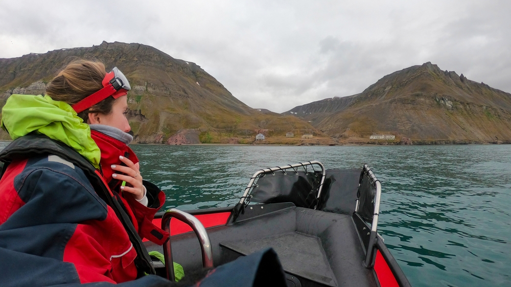 Traveler woman in an Arctic rib boat