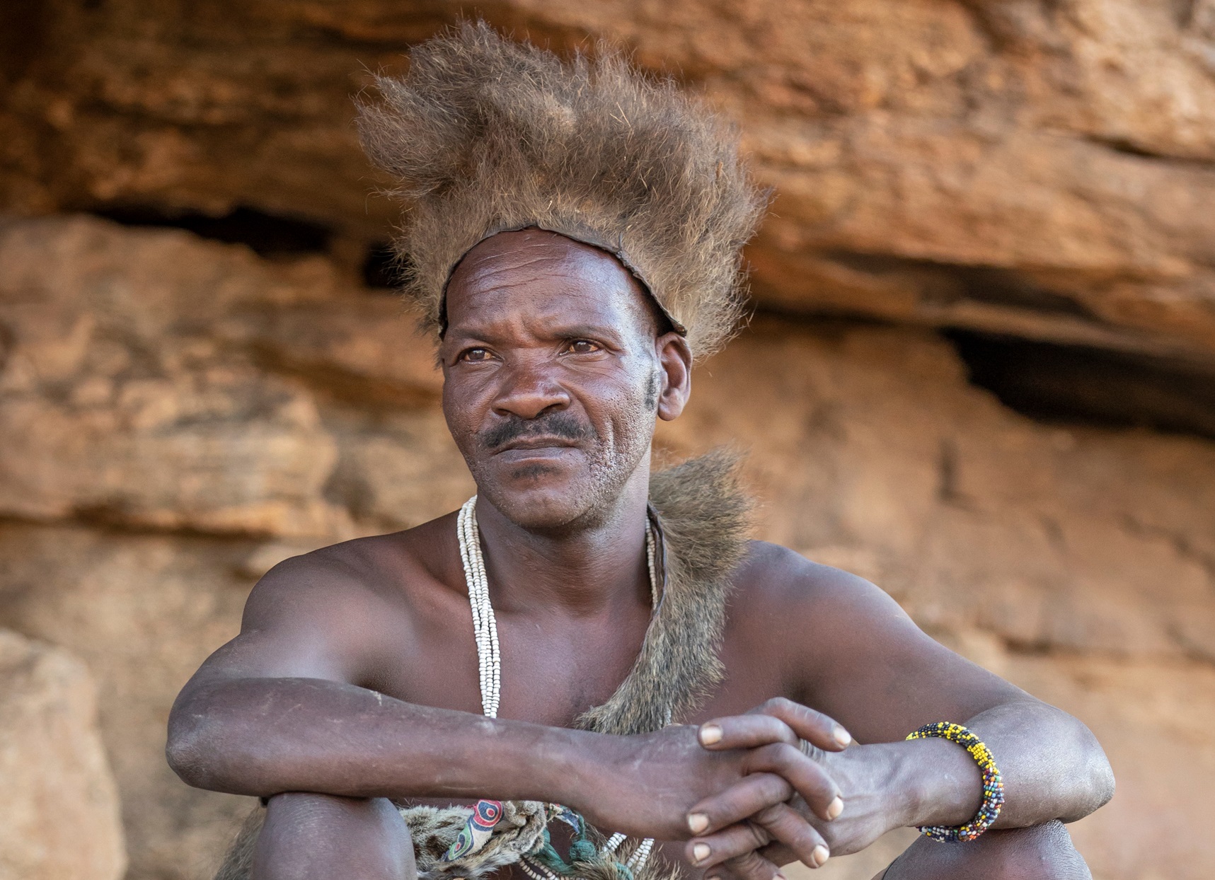 Lake Eyasi, Tanzania, 11th September 2019: Hadzabe man resting in a cave