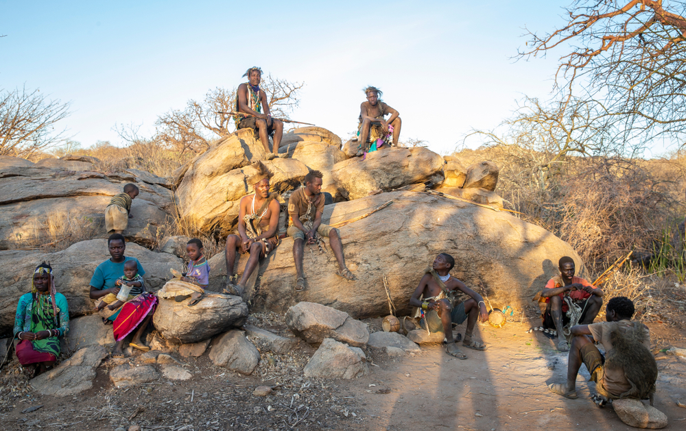 Hadzabe men on a rock with his bow and arrows - 2019