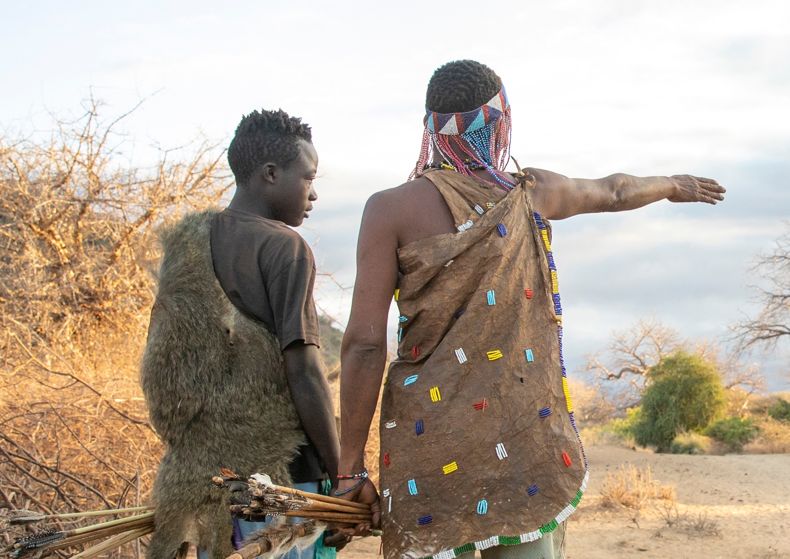 Hadzabe men planning their morning hunt at sunrise - 2019