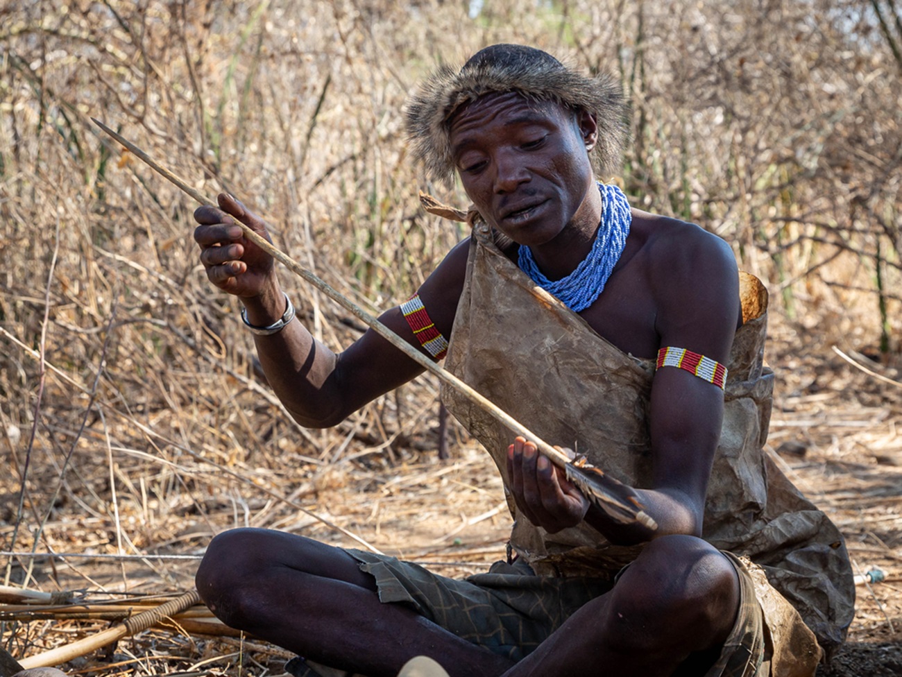 Hadzabe hunter sharpening his weapons during his resting day - 2020