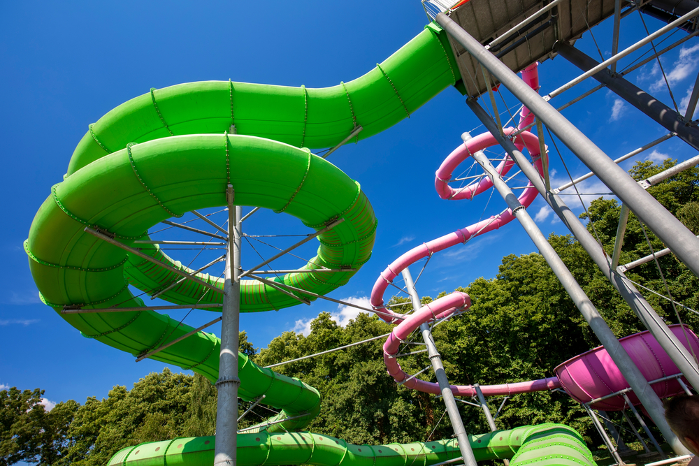Green and pink water slide in aquapark