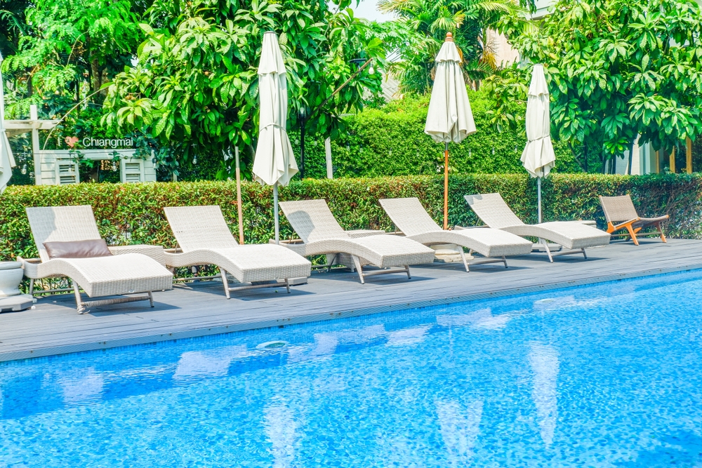 Empty swimming pool with sunbed