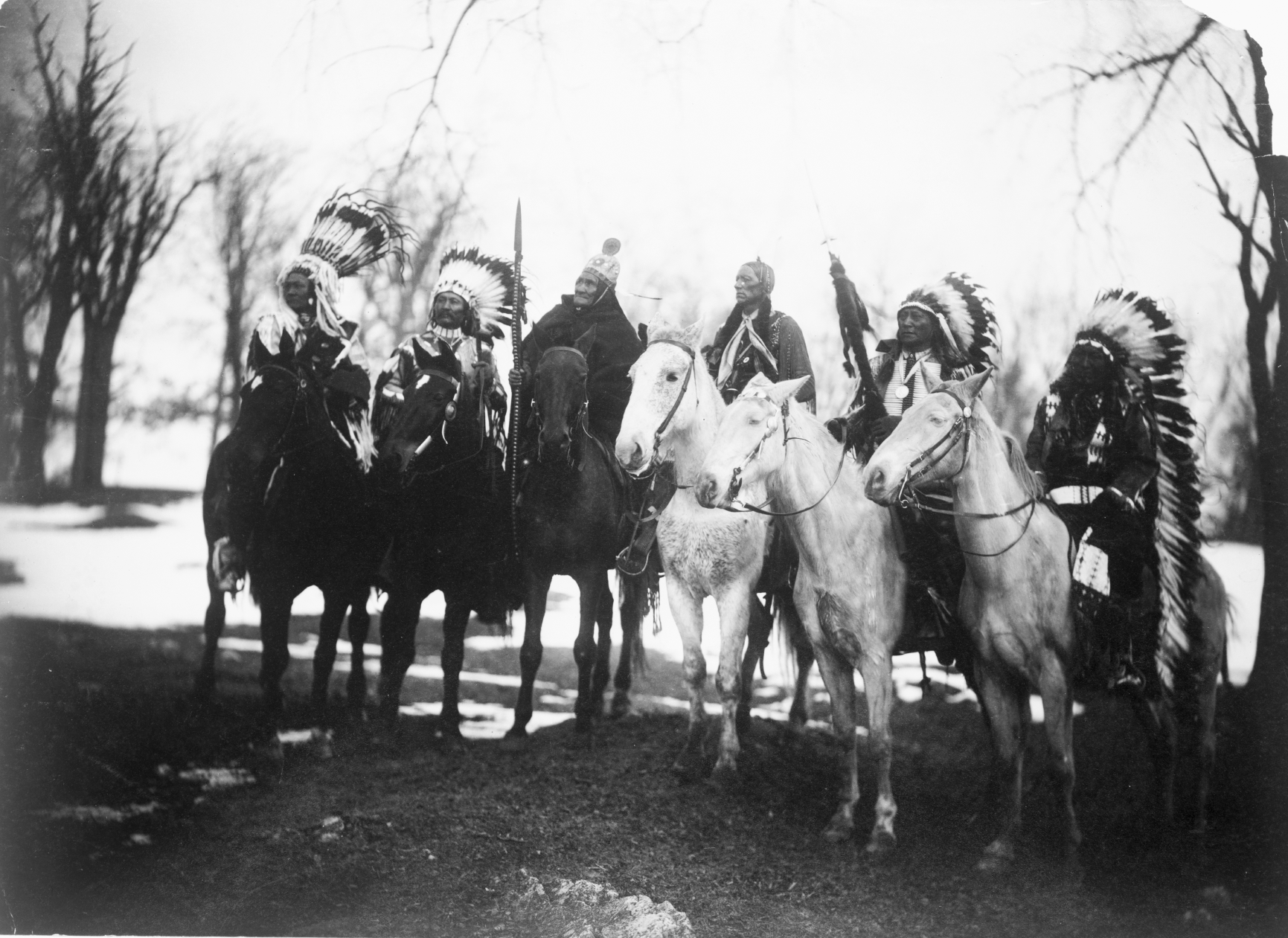 Six Tribal Leaders on horseback in ceremonial attire - circa 1900