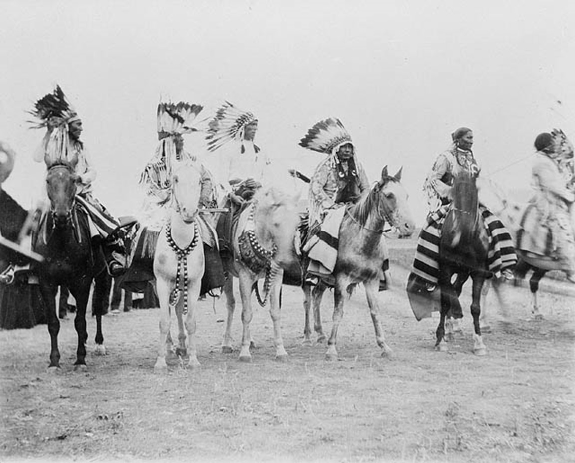 A group of men riding on the backs of horses