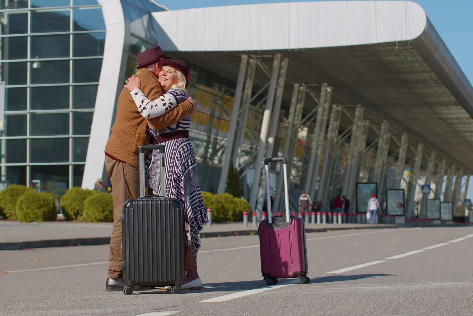 Elderly old grandmother grandfather retirees tourists reunion in airport terminal