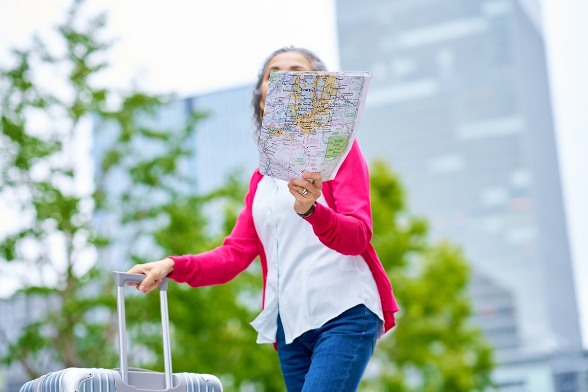 Senior woman walking with map in hand