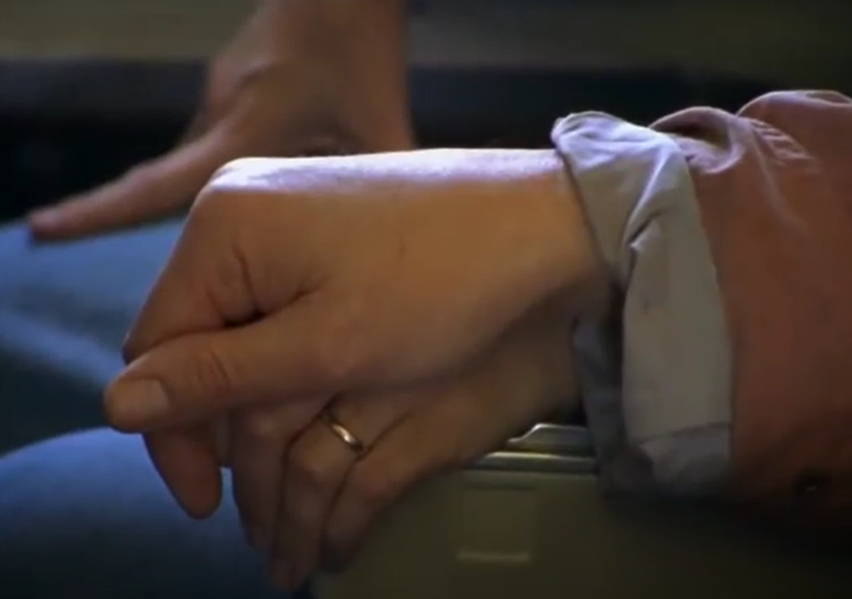 Screenshot of  Juliane Koepcke holding hands in plane - from Miracles Still Happen (1974)