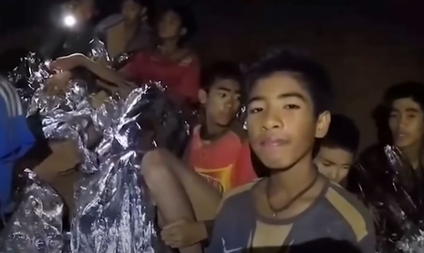 Screenshot of scared kids in the cave - from Thai Cave Rescue (Drain the Oceans) 2019