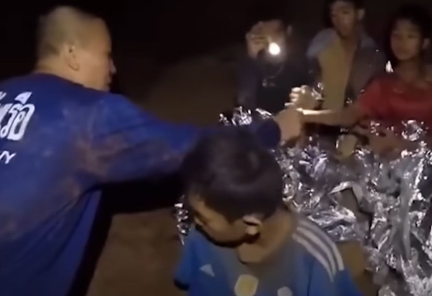 Screenshot of scared kids in the cave - from Thai Cave Rescue (Drain the Oceans) 2019