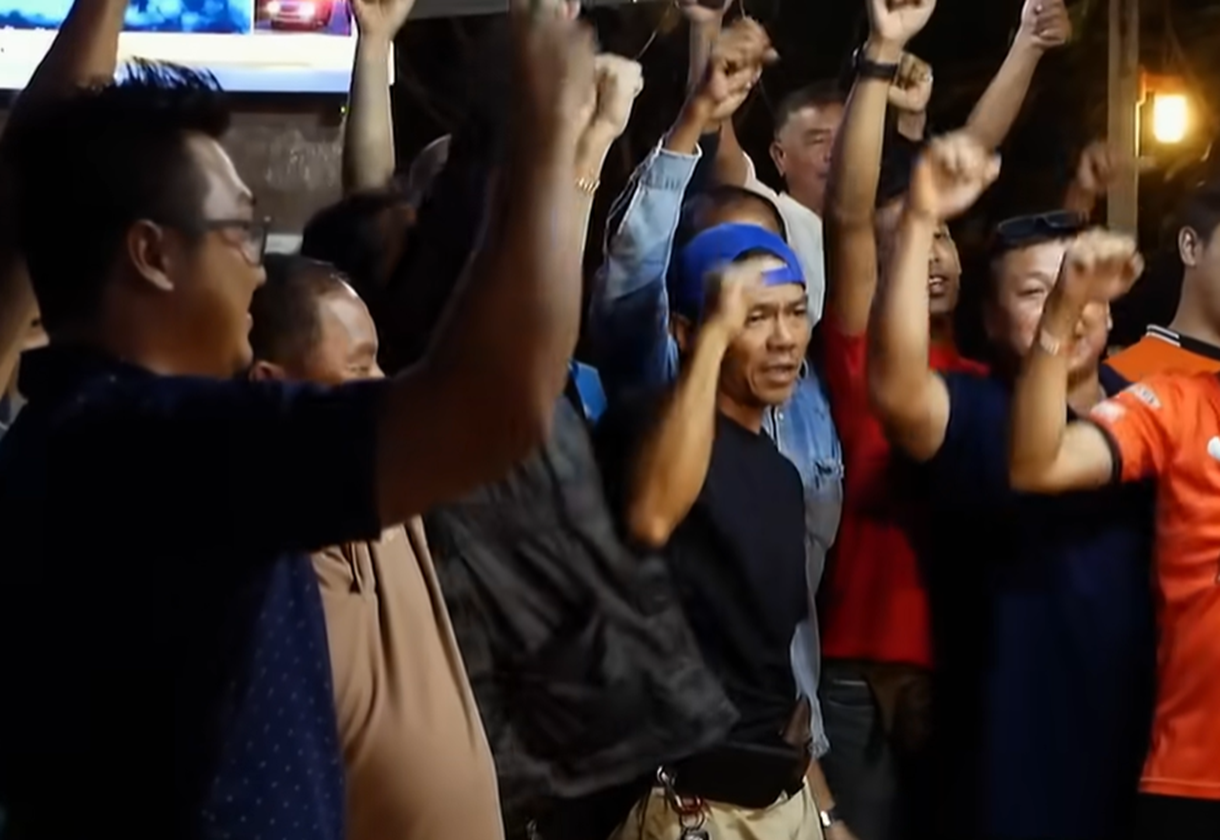 Screenshot of people outside the cave - from Thai Cave Rescue (Drain the Oceans) 2019