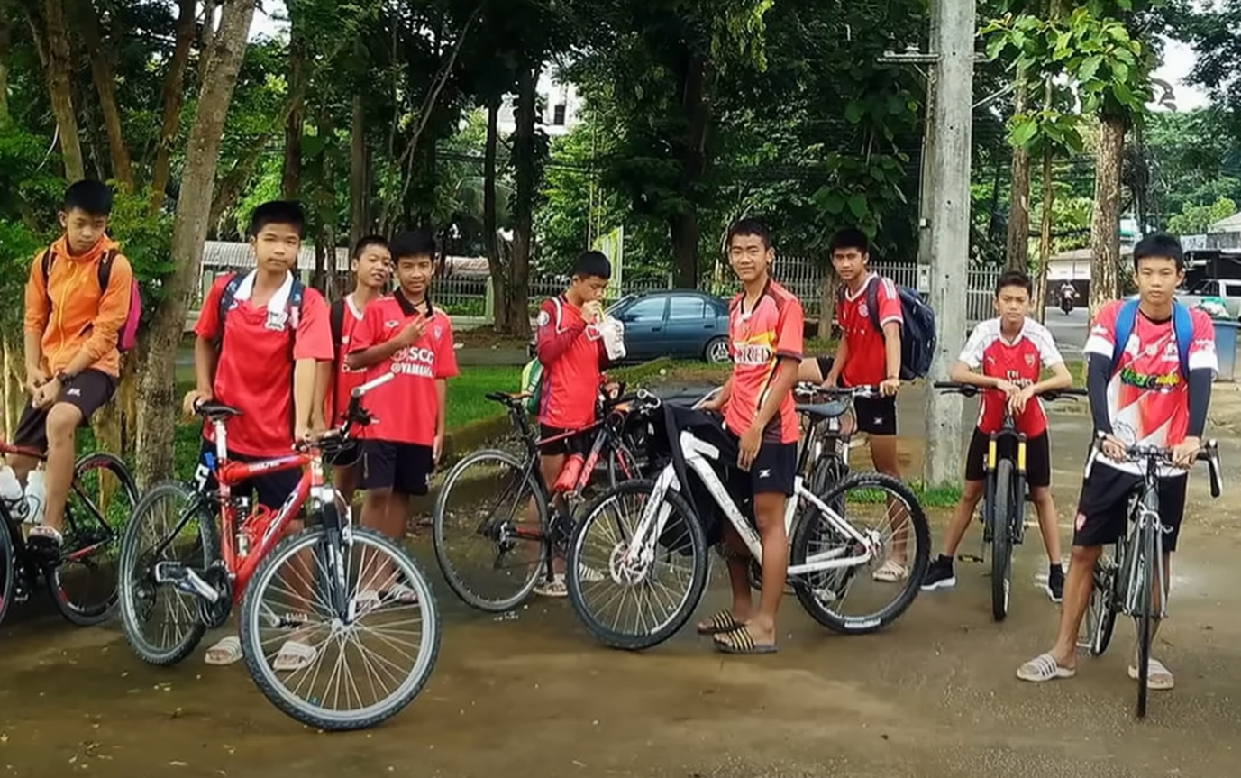 Screenshot of kids driving bikes - from Thai Cave Rescue (Drain the Oceans) 2019