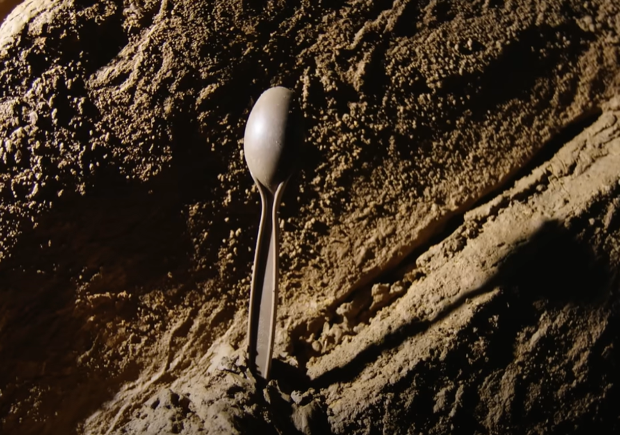 Screenshot of plastic spoon in the cave - from Thai Cave Rescue (Drain the Oceans) 2019