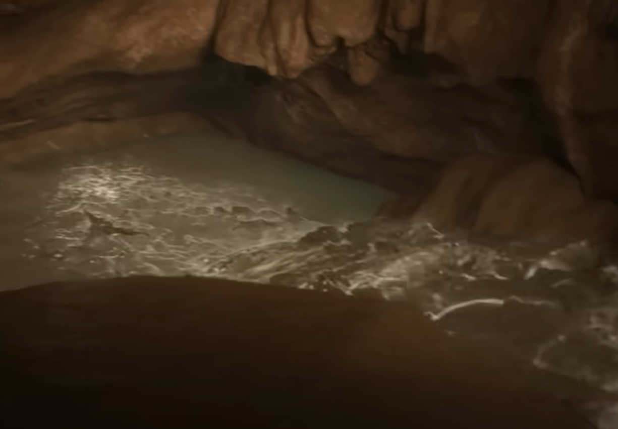 Screenshot of running water in the cave - from Thai Cave Rescue (Drain the Oceans) 2019