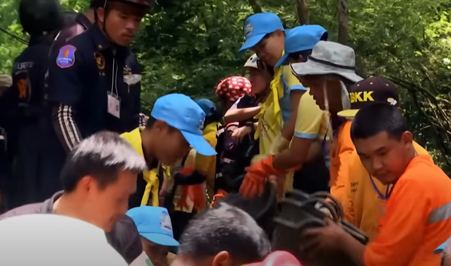 Screenshot of rescue divers in the cave - from Thai Cave Rescue (Drain the Oceans) 2019