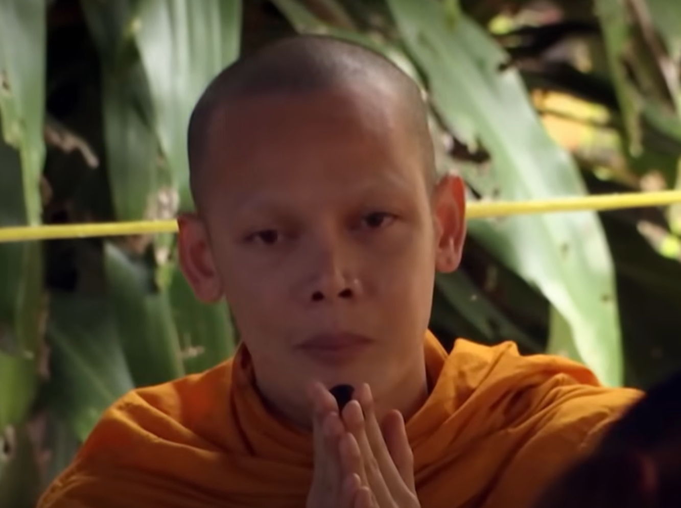 Screenshot of people pray in the cave - from Thai Cave Rescue (Drain the Oceans) 2019