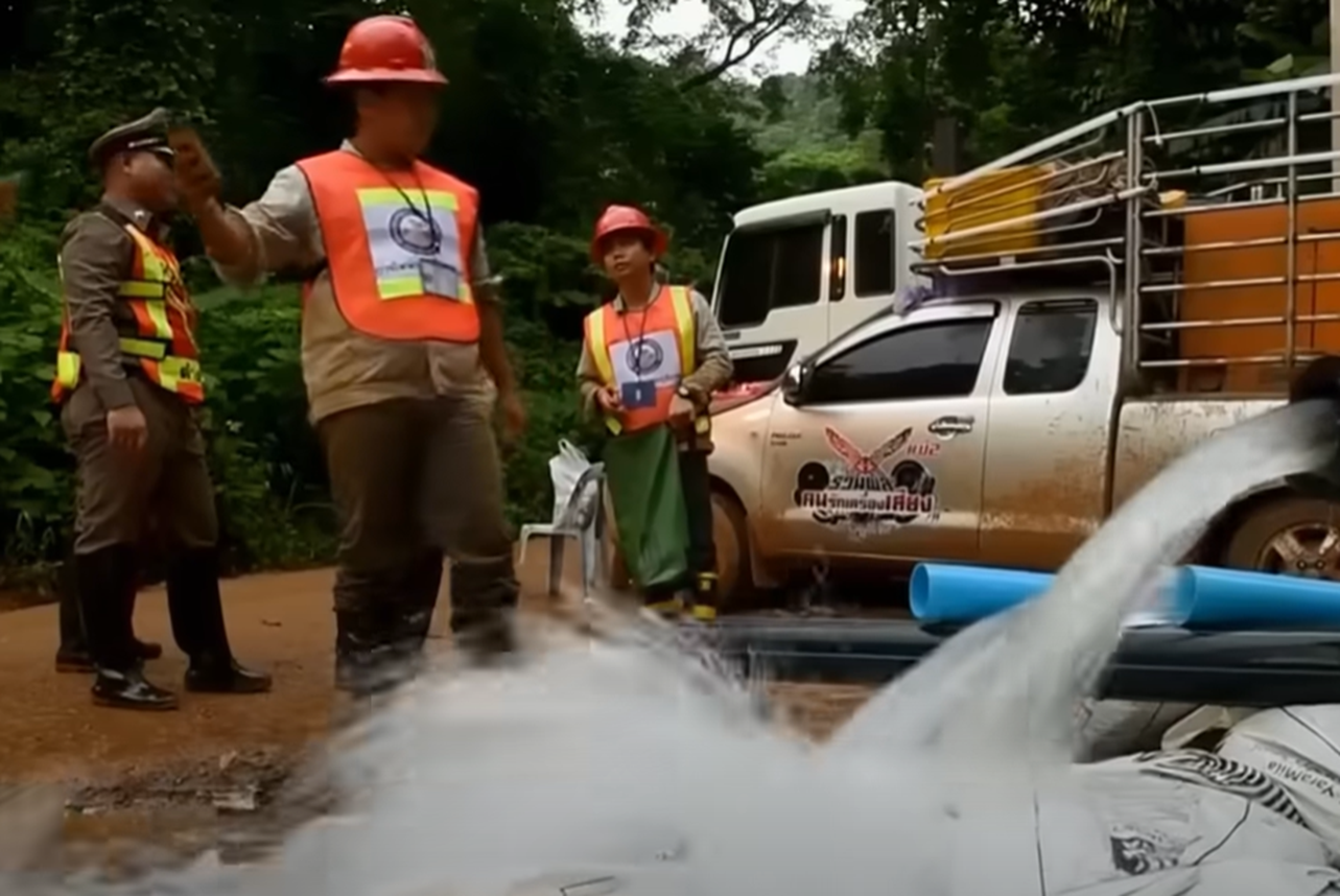 Screenshot of rescue people pumping water from the cave - from Thai Cave Rescue (Drain the Oceans) 2019