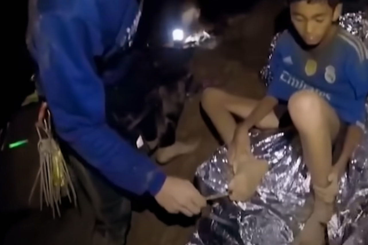 Screenshot of scared kids in the cave - from Thai Cave Rescue (Drain the Oceans) 2019