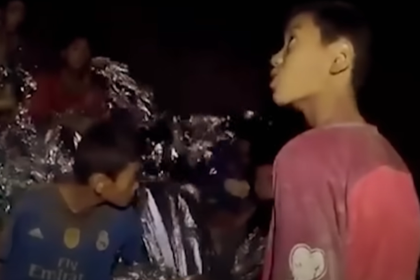 Screenshot of scared kids in the cave - from Thai Cave Rescue (Drain the Oceans) 2019