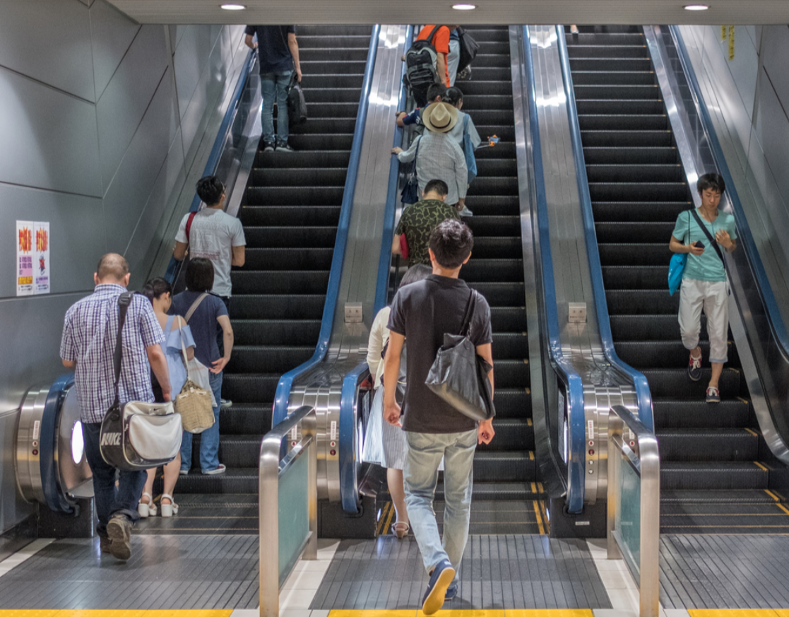People riding elevator at Tokyo train station - 2017