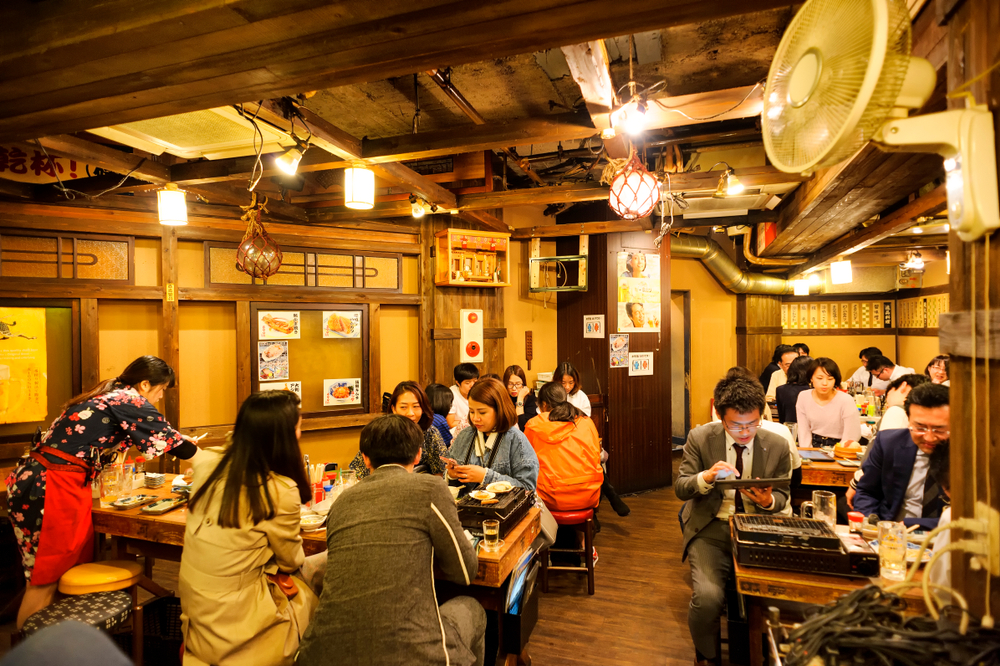 People eating at restaurant in Japan.