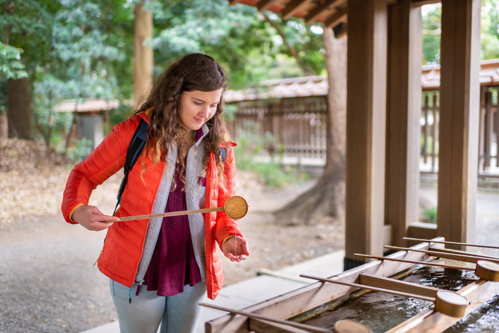 Meiji shrine entrance, water purification fountain with tourist