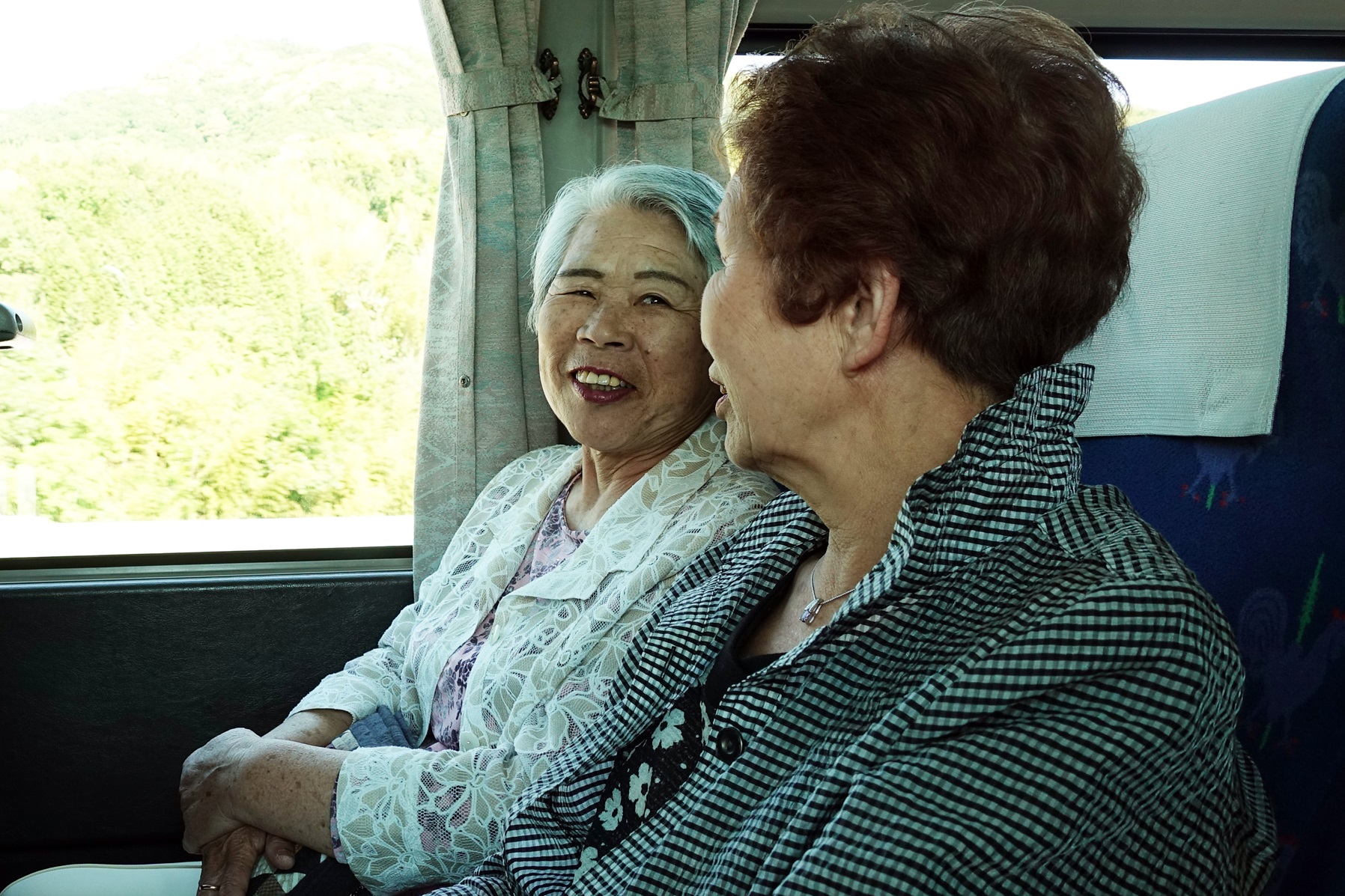 Senior people having a bus trip in Japan.