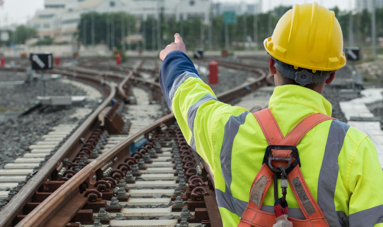 worker on a construction site. Engineer sitting on railway inspection. construction worker on railways. Engineer work on Railway. Rail, engineer, Infrastructure.