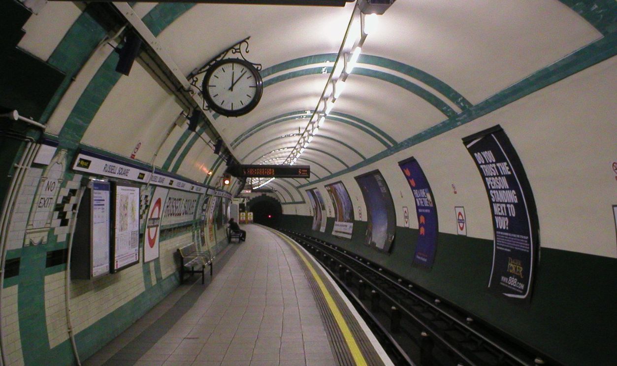 Looking down the length of a platform in Russell Square tube station on the London Underground.