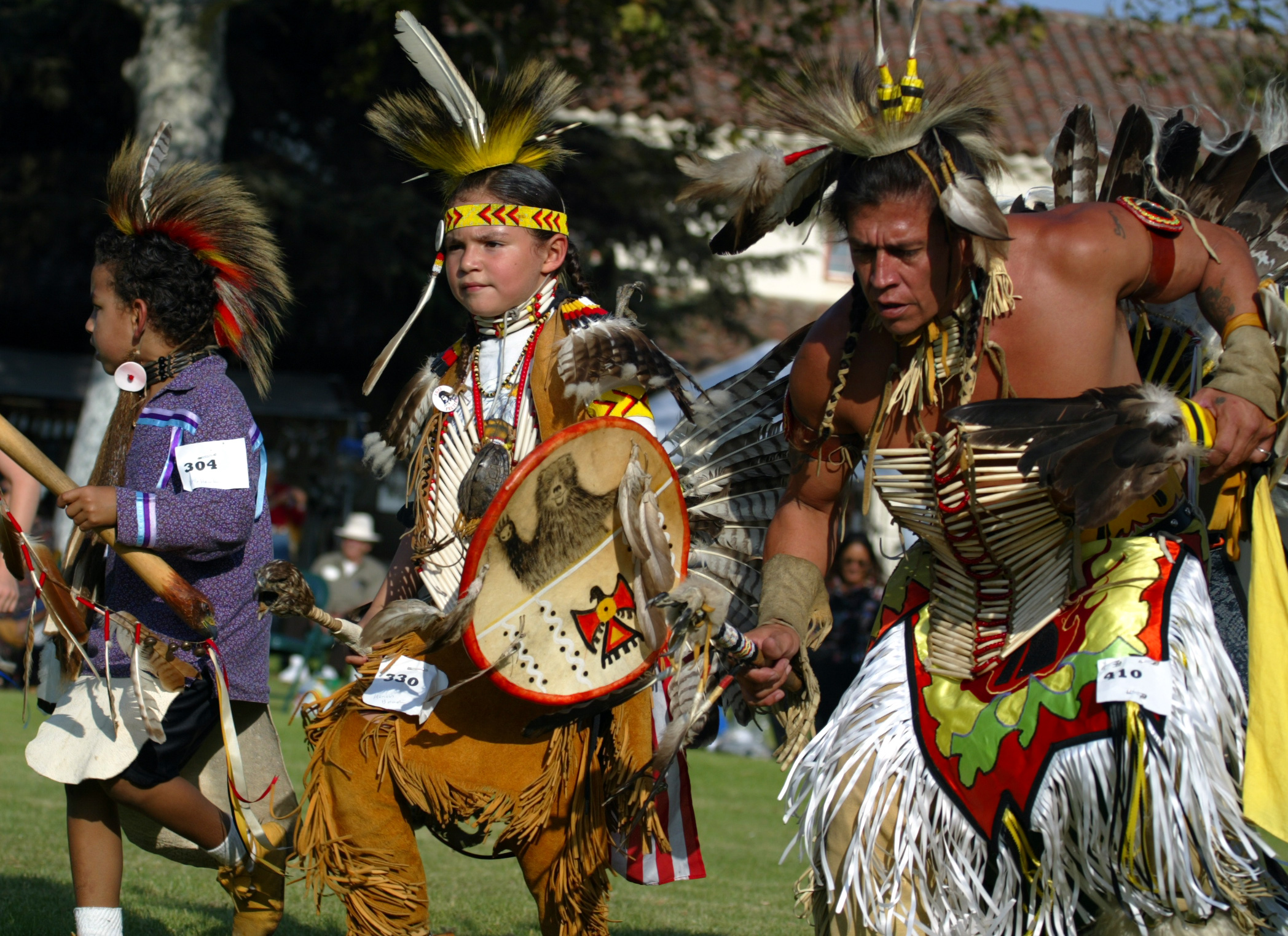 Little Hawk, left, Honovi Bear, (their proper names according to mother) and Sam Bearpaw dance in th