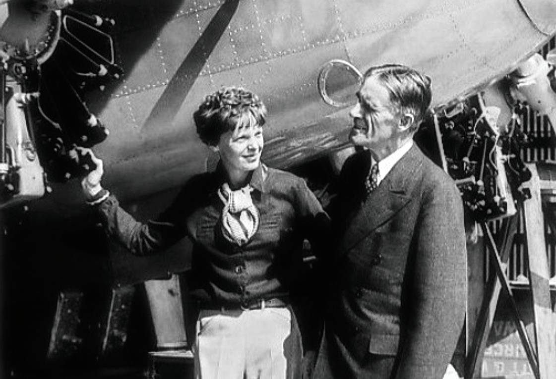 Amelia Earhart with her plane Electra