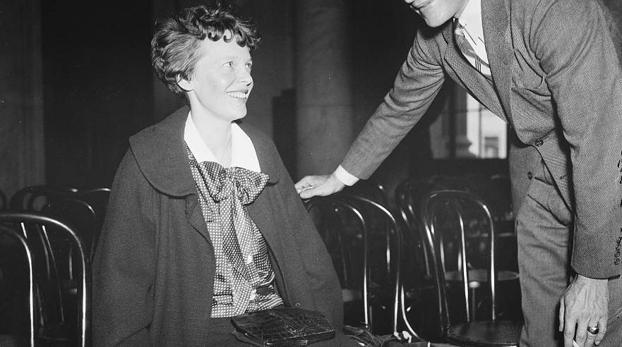 Amelia Earhart sitting on a chair